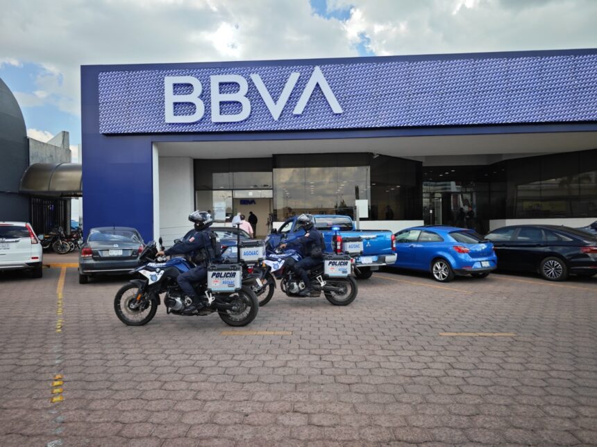 Elementos de la Policía Estatal de Aguascalientes en motocicletas frente a una sucursal bancaria.